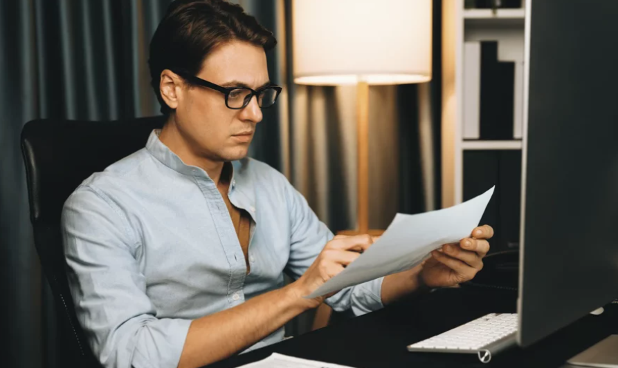 Imagem de um empresário analisando documentos